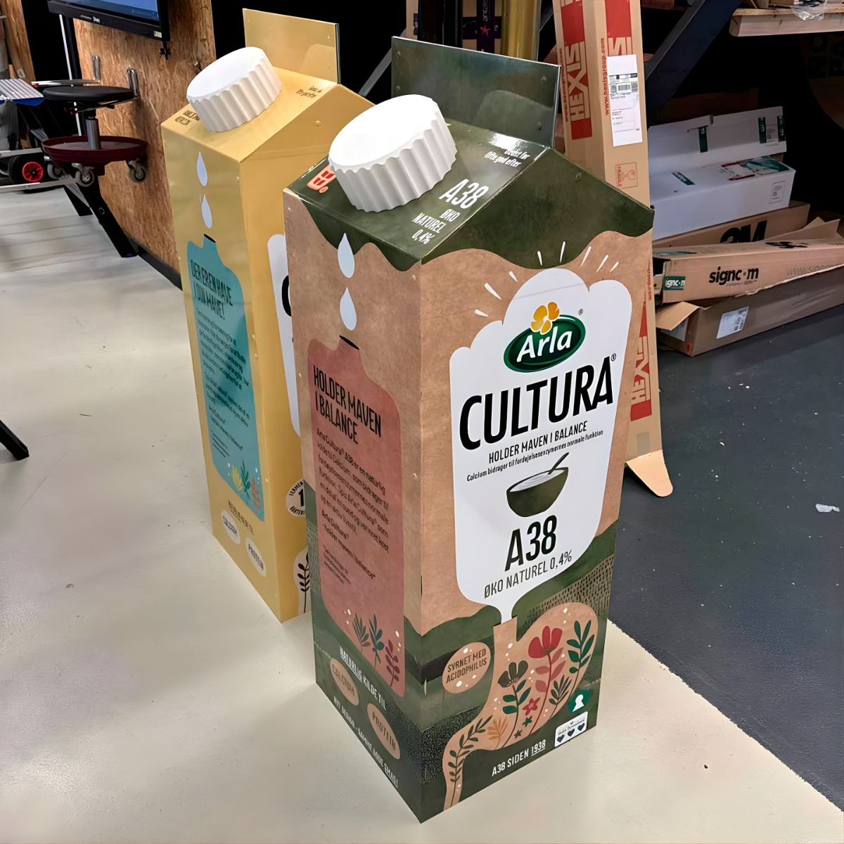 Store kartoner med yoghurt CULTURA på i gul og grøn farve